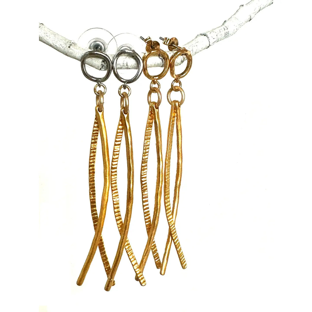 Gold and silver earrings on a white background